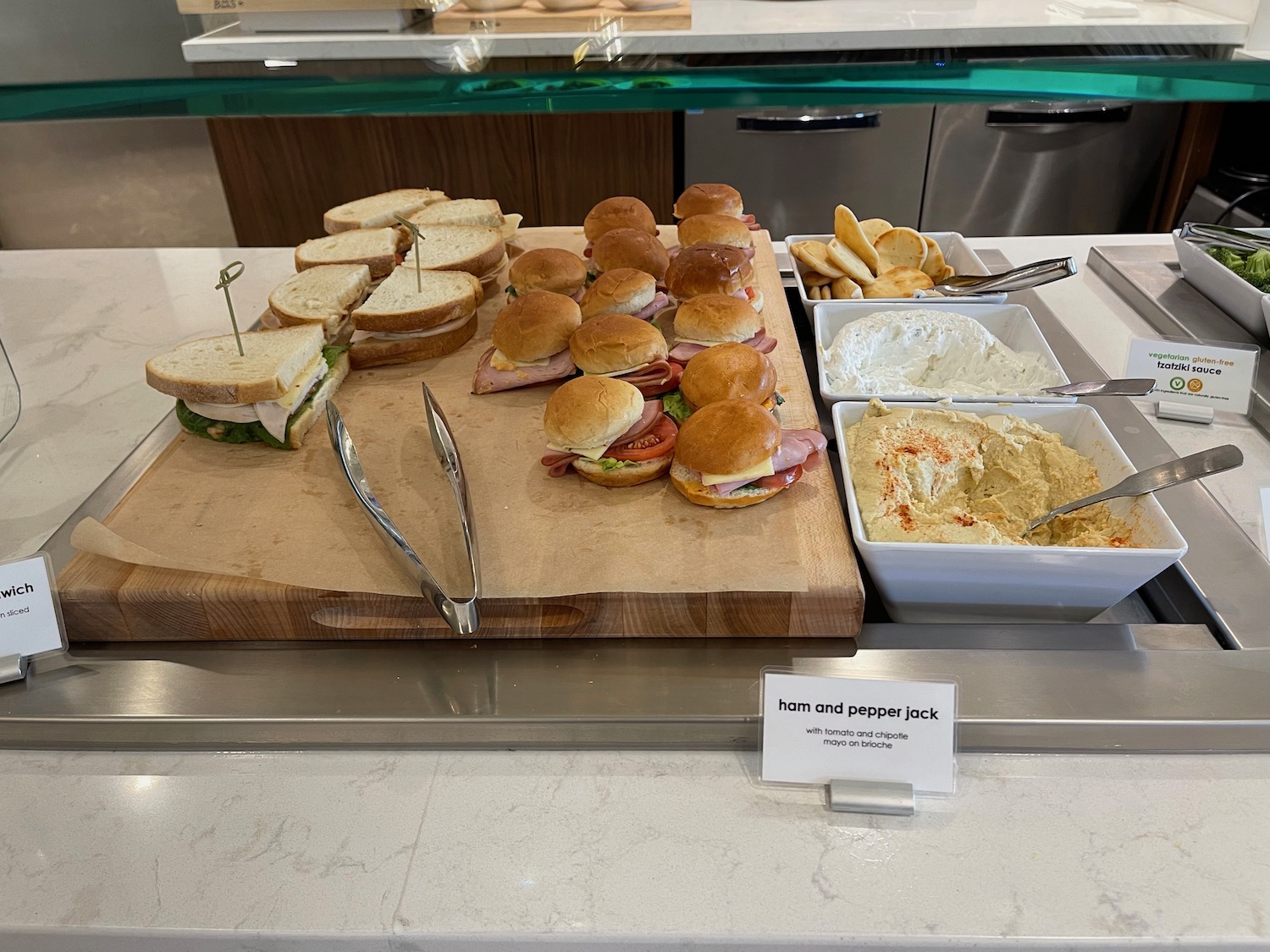 a table with sandwiches and dips