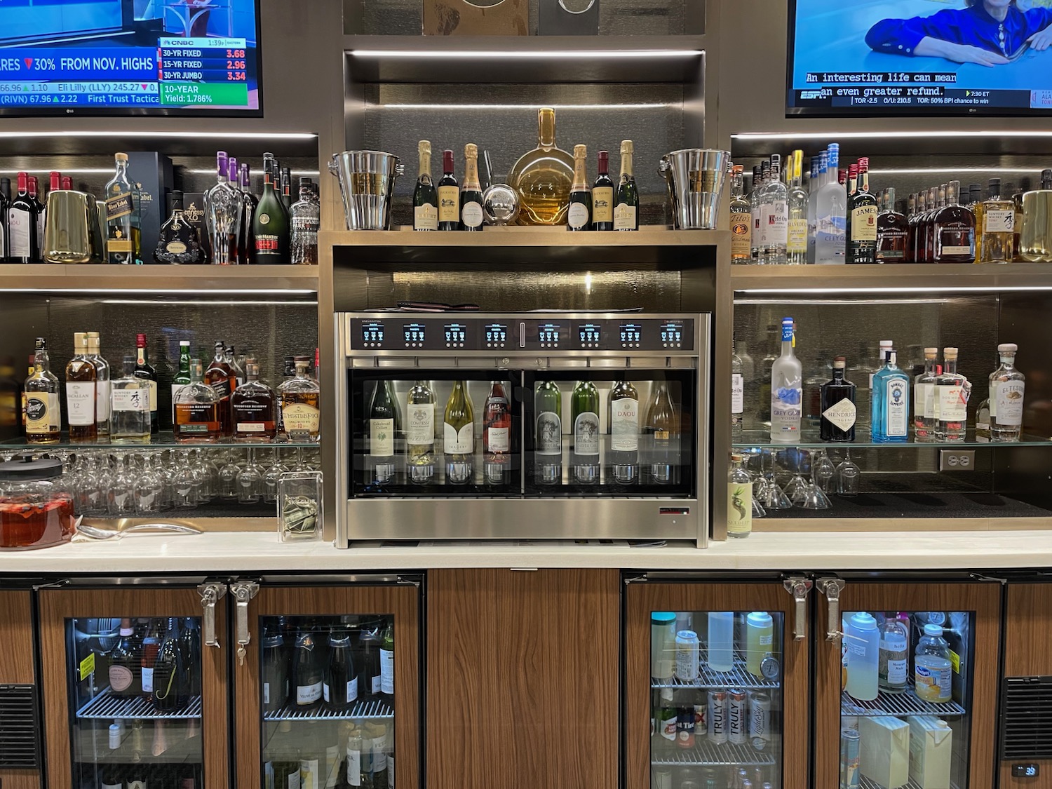 a bar with shelves of liquor and a television