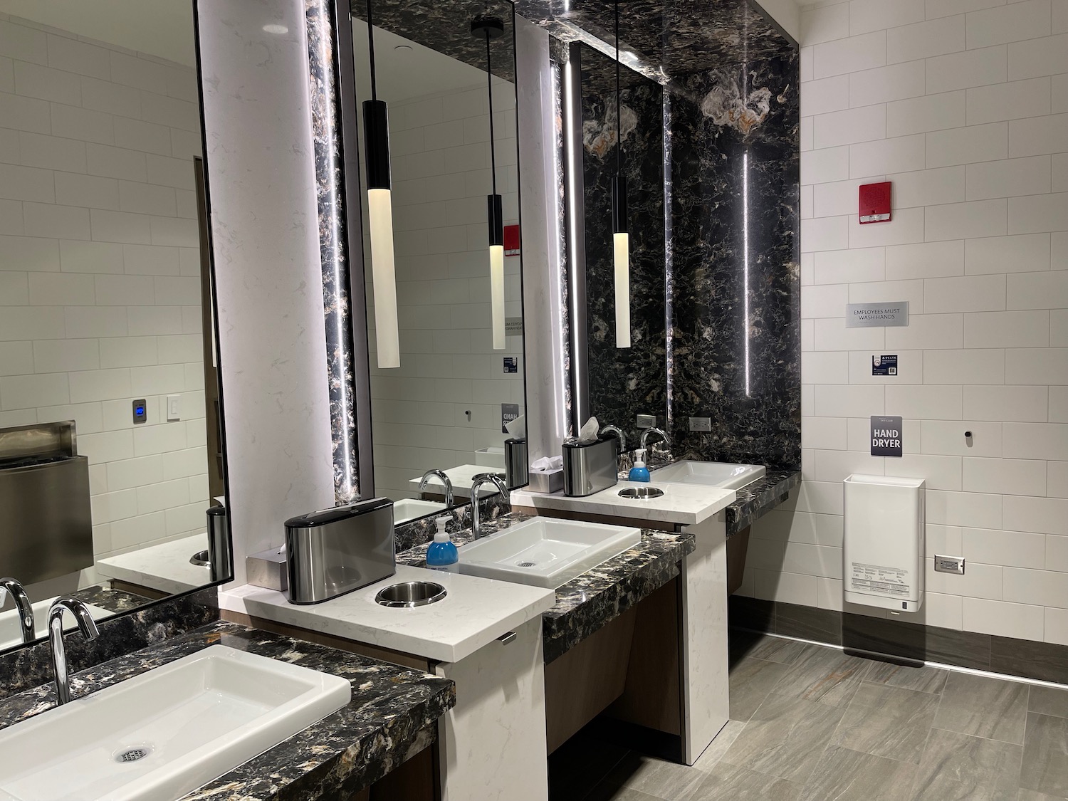 a bathroom with sinks and mirrors