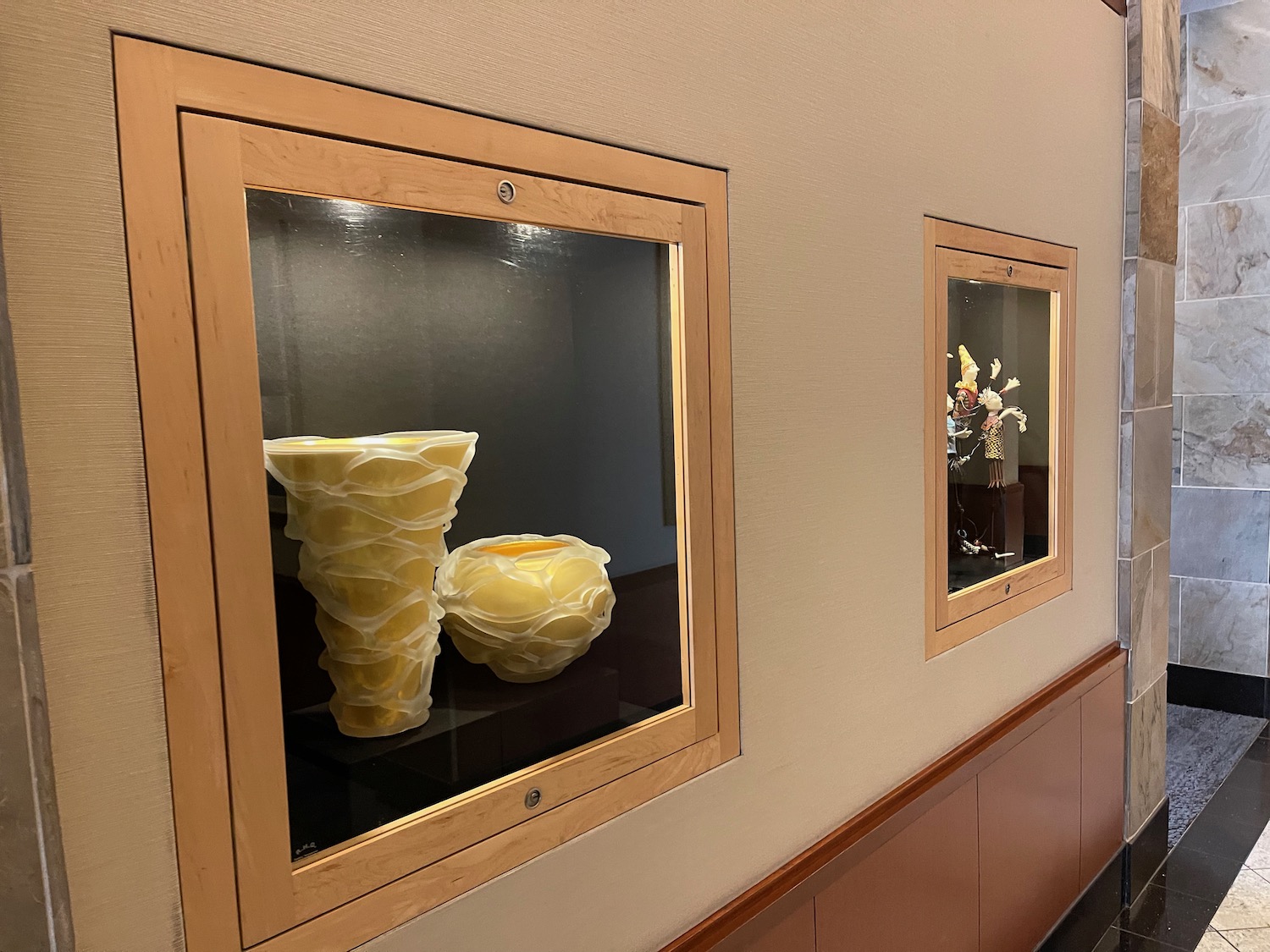 a display case with a vase and a vase in it