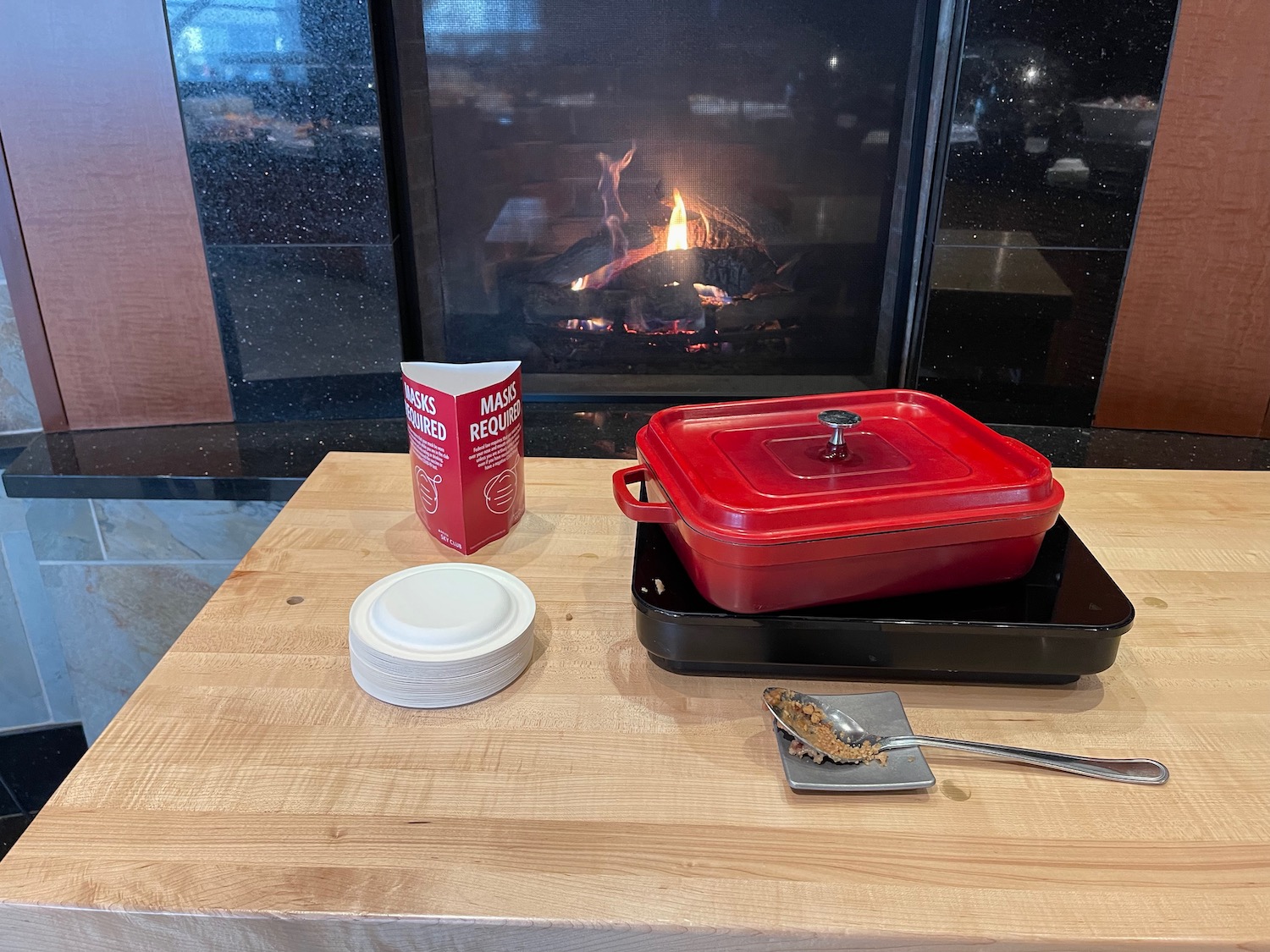 a red pan on a table next to a red container