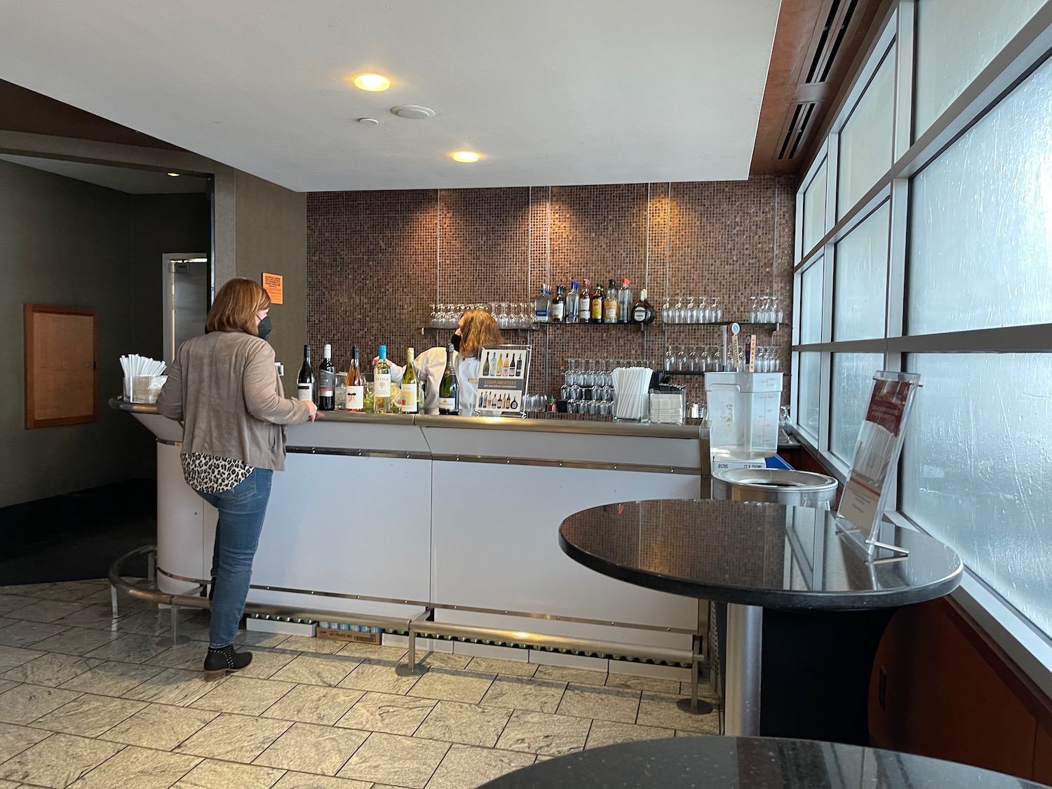 a woman standing at a bar