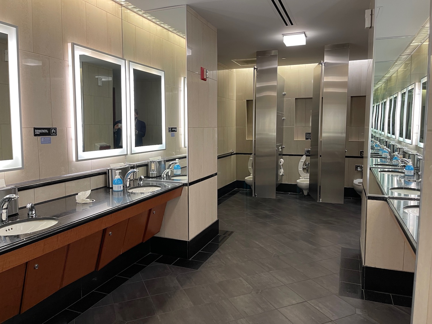 a bathroom with mirrors and sinks