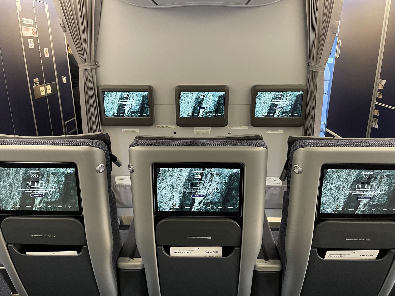 a row of seats with screens on the back