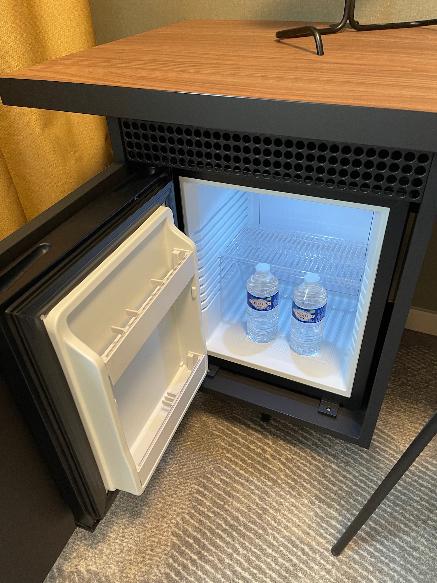 a small refrigerator with two bottles of water inside