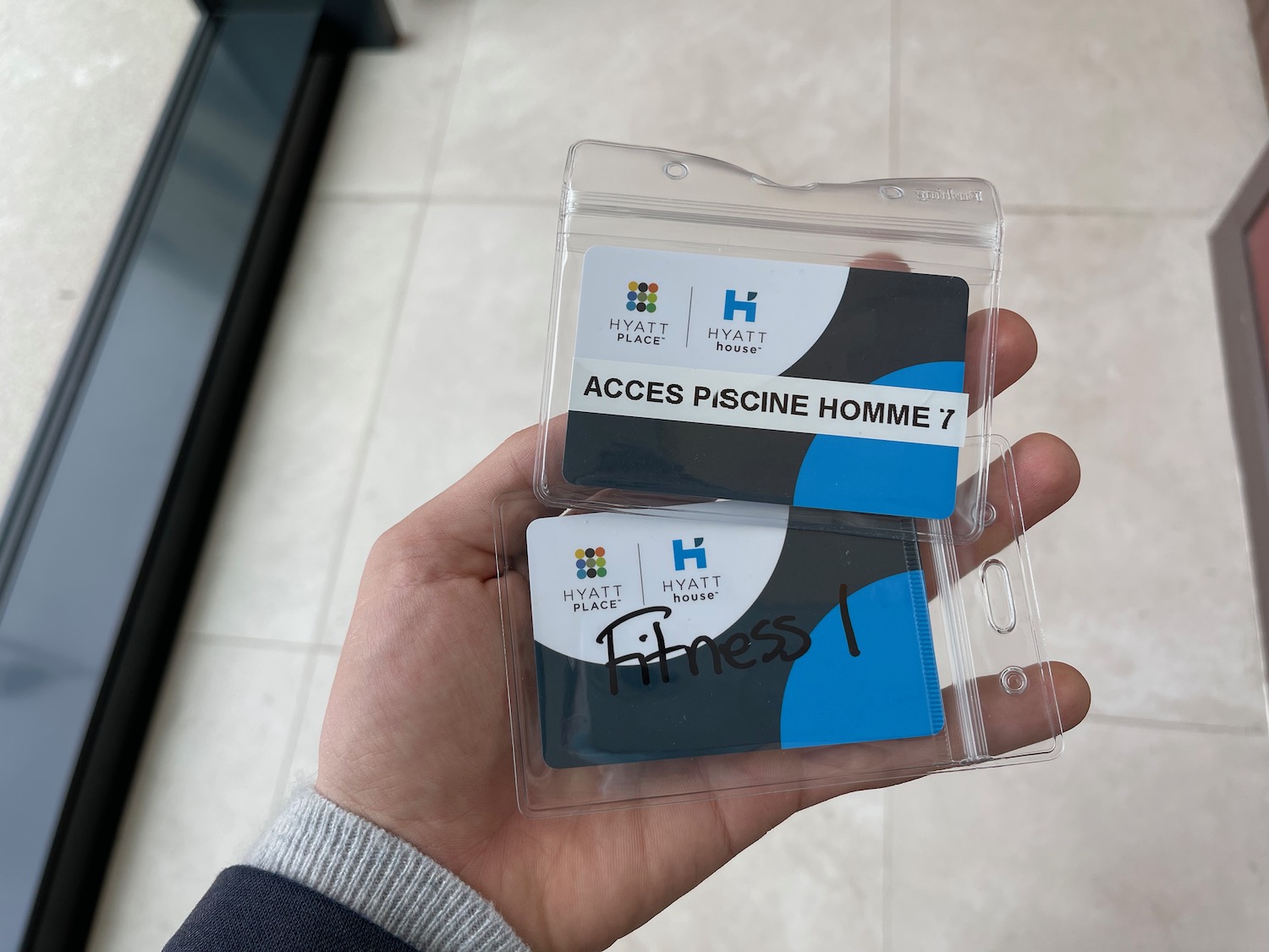 a hand holding a plastic package with a blue and black card