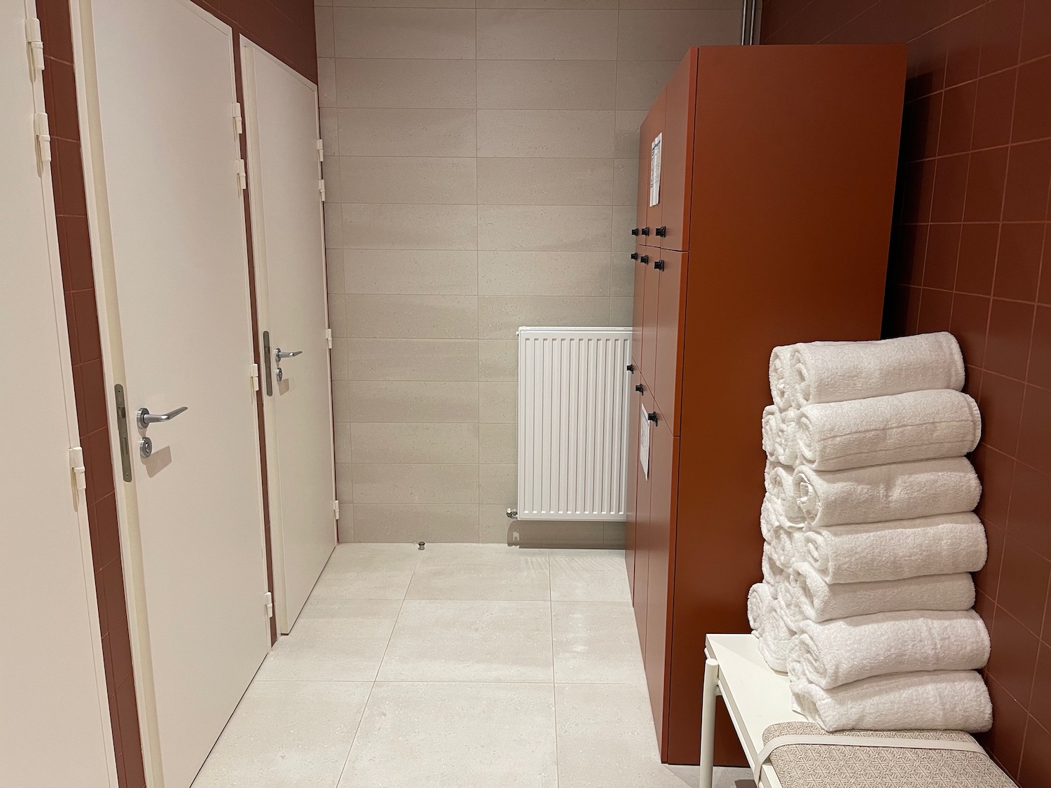 a bathroom with white towels and cabinets