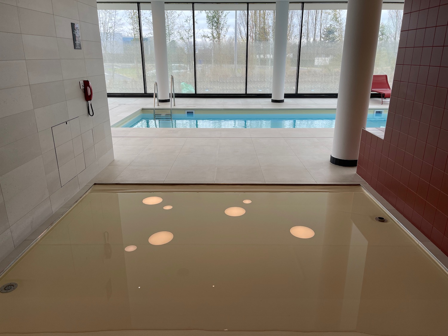 a pool with lights on the floor