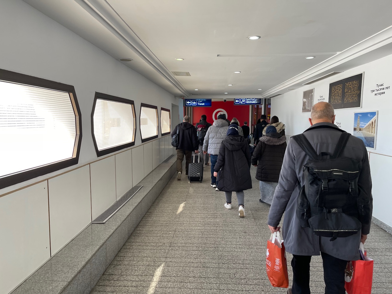 a group of people walking in a hallway