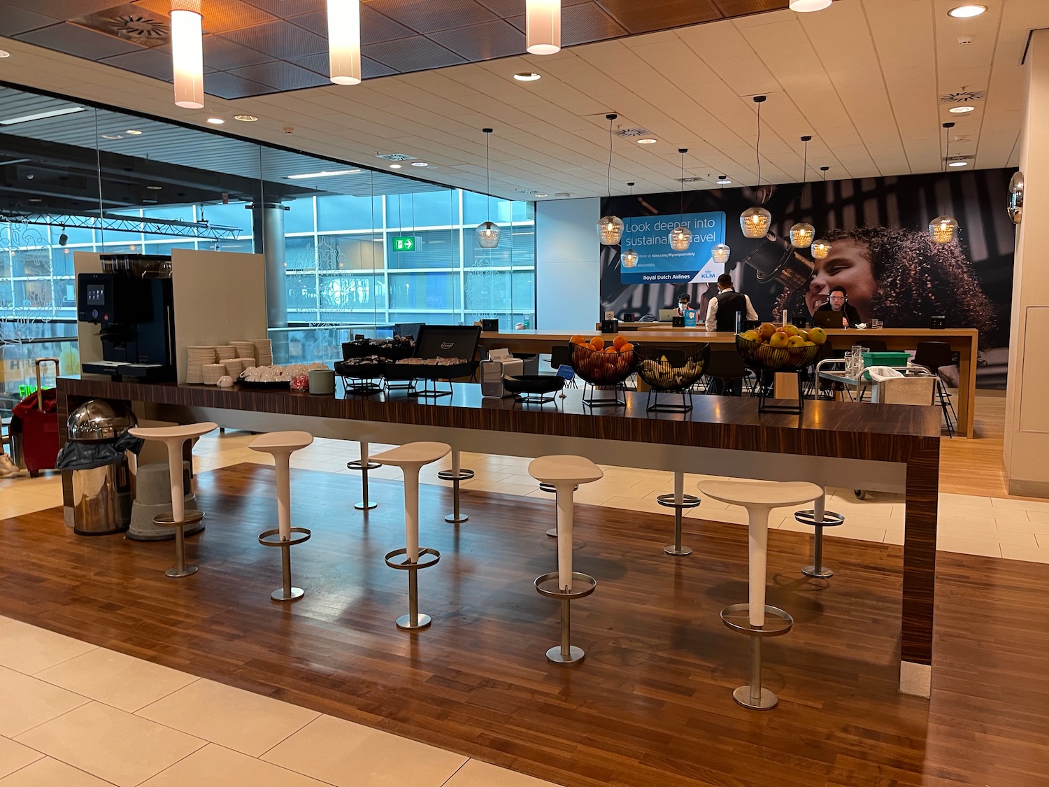 a bar with stools and a table in a building