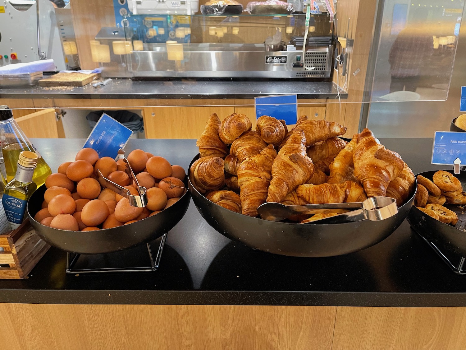 a bowl of croissants and eggs on a counter