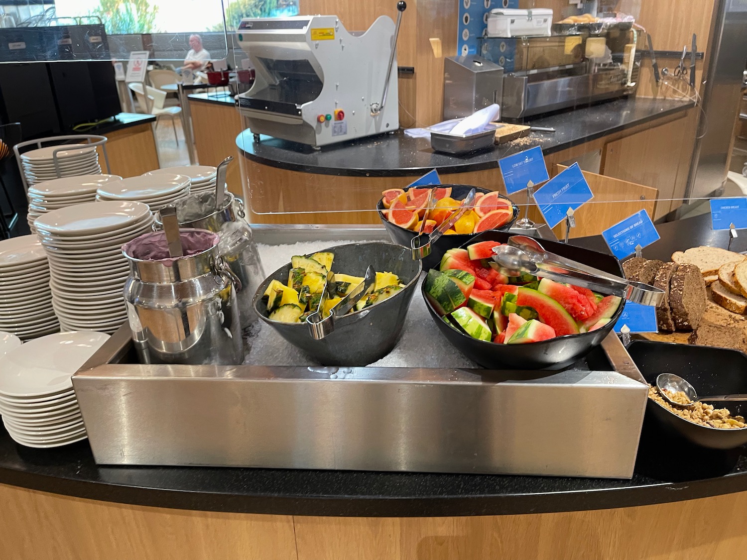 a buffet with bowls of fruit and vegetables