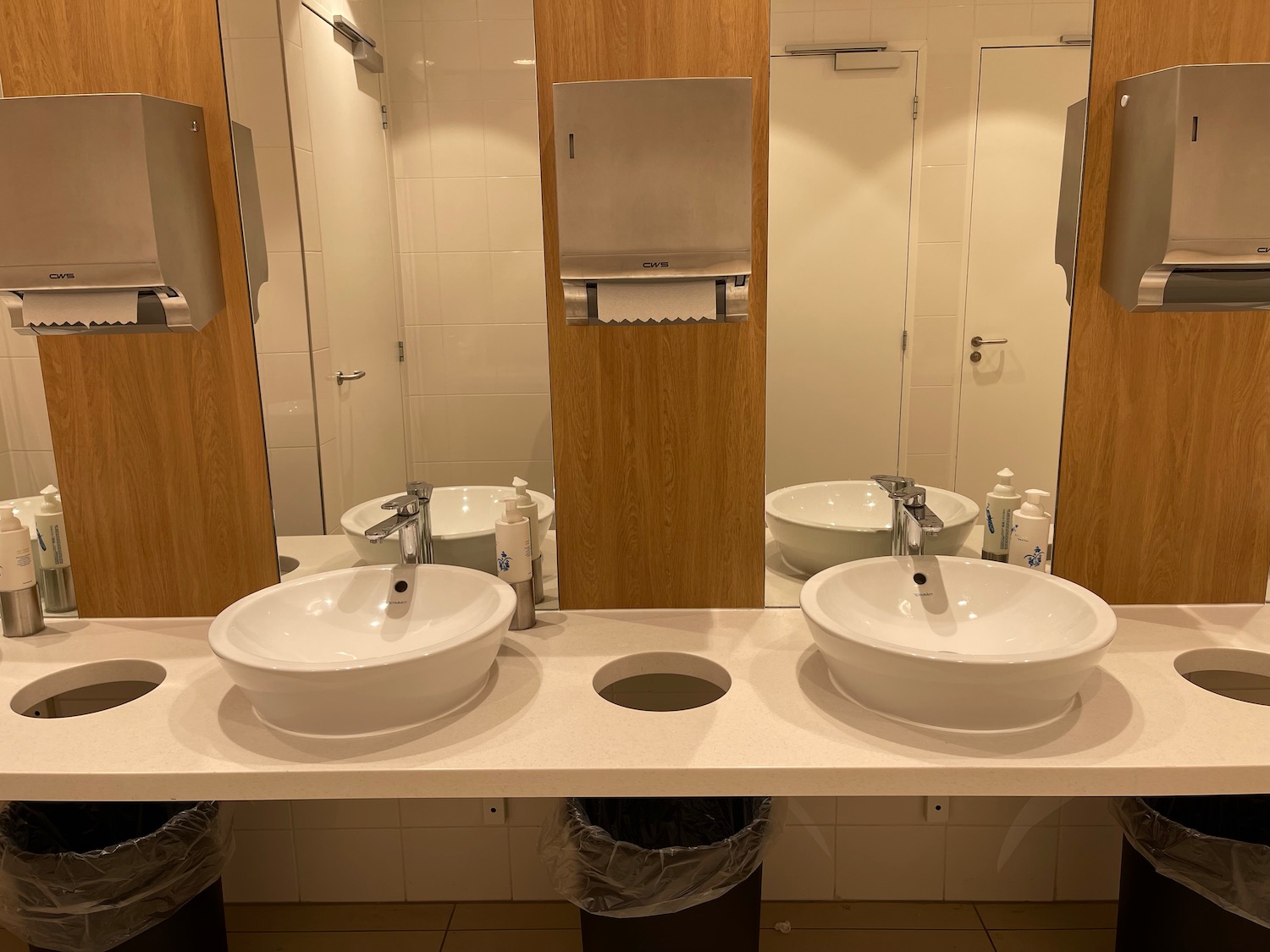 a bathroom with sinks and mirrors