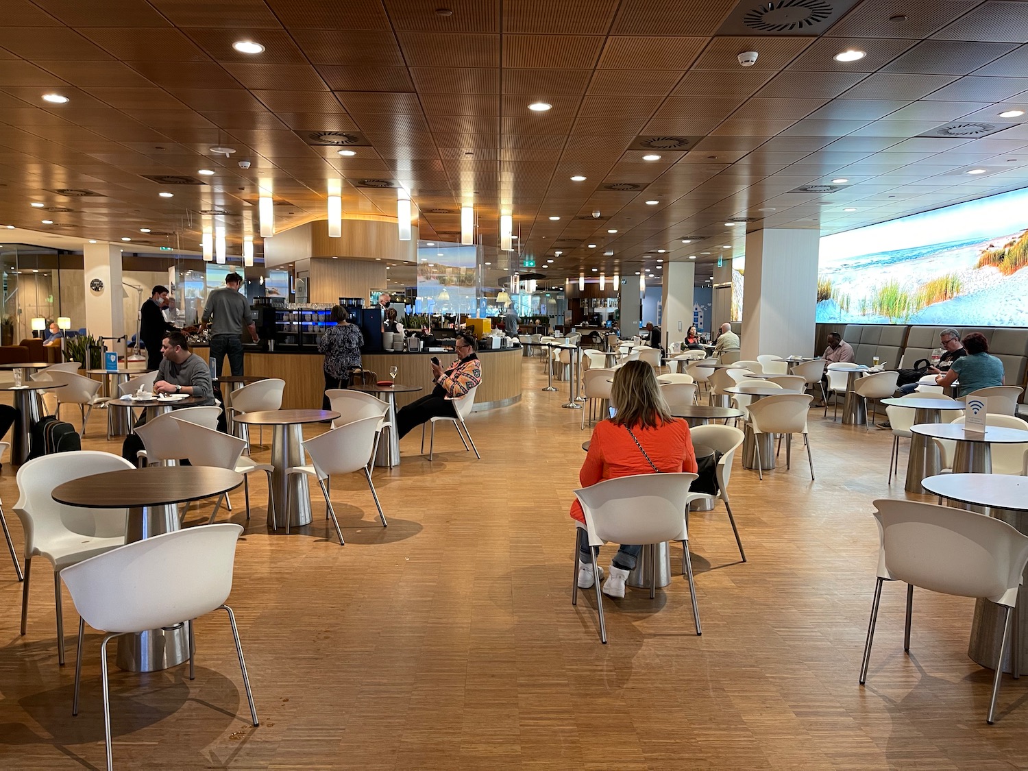 people sitting at tables in a large room