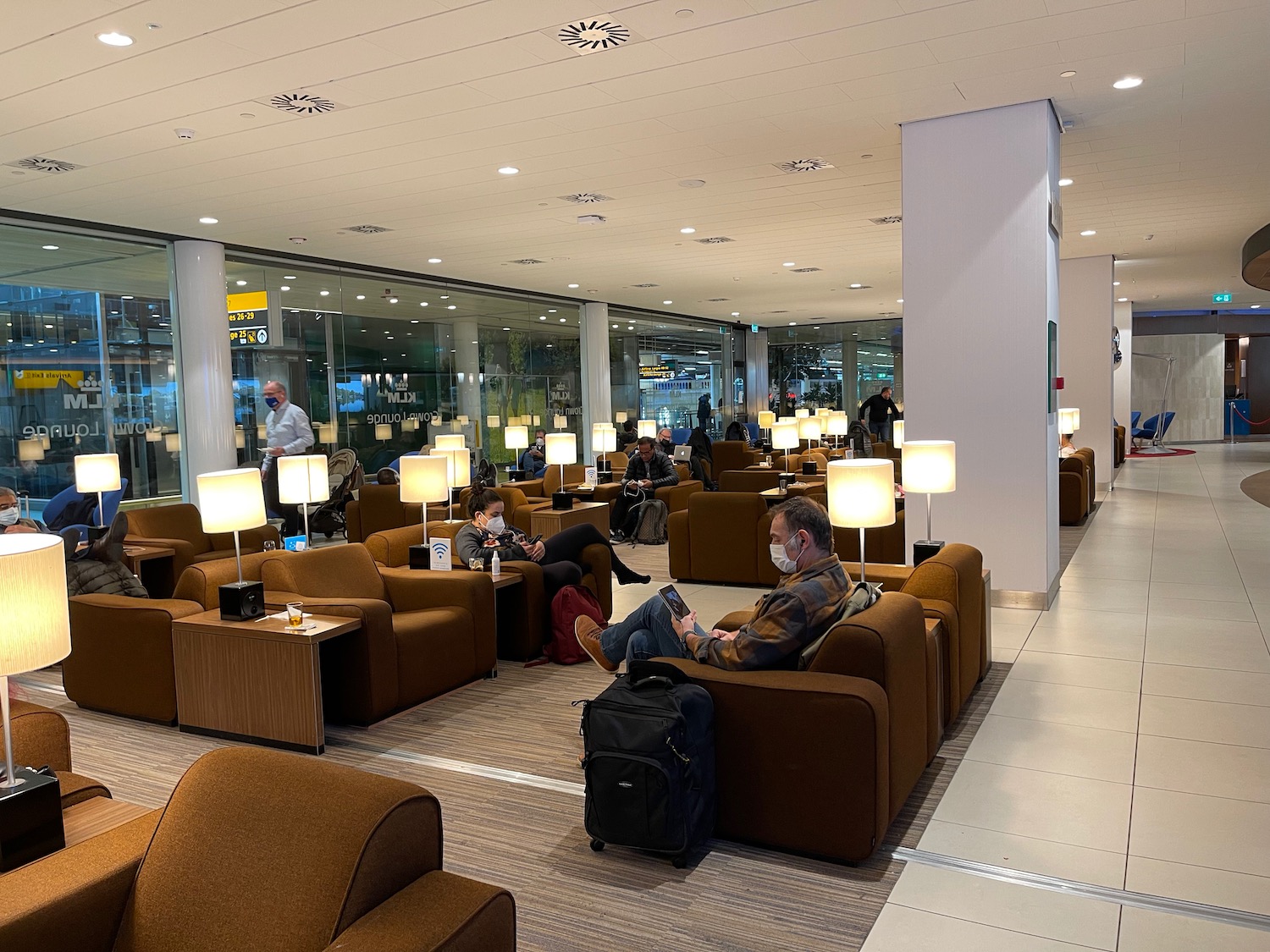 people sitting on chairs in a lounge area