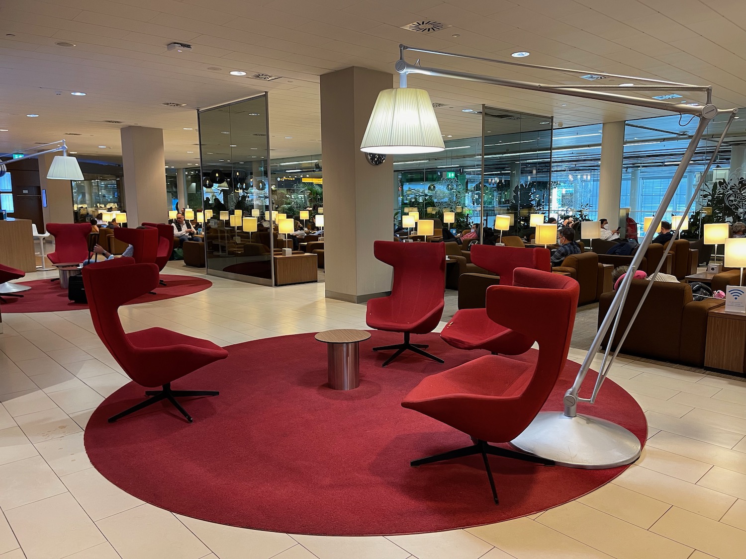 a room with red chairs and a lamp