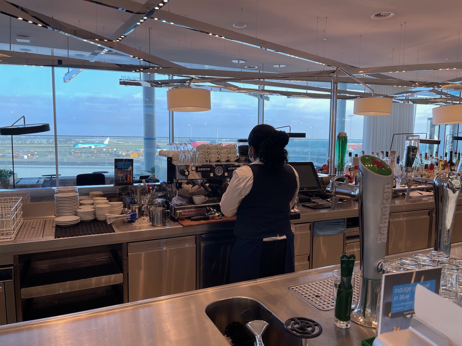 a woman standing behind a counter in a restaurant