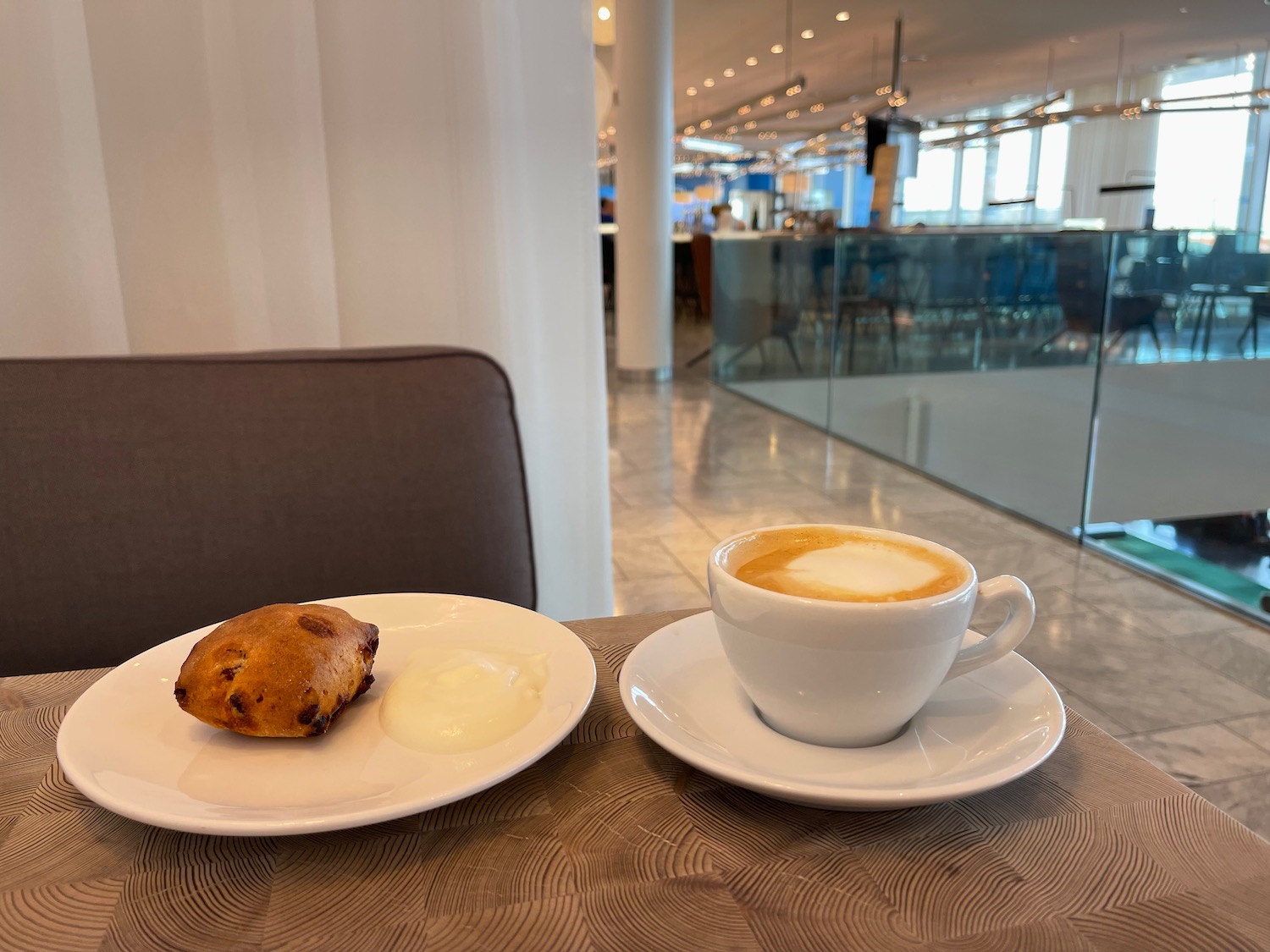 a plate of coffee and a pastry on a table
