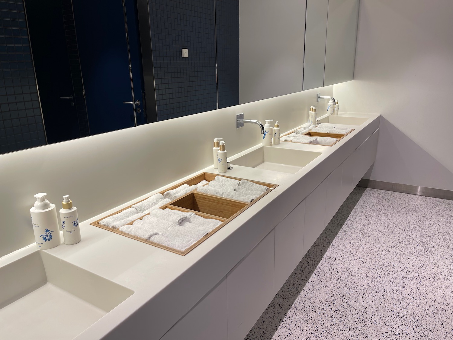 a bathroom with sinks and soaps