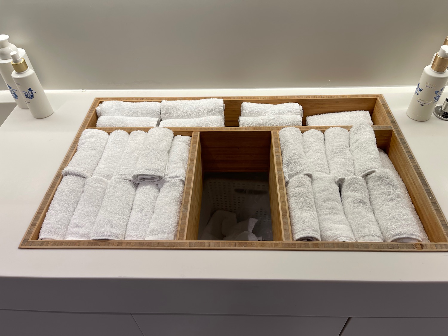 a wooden box with rolled towels inside