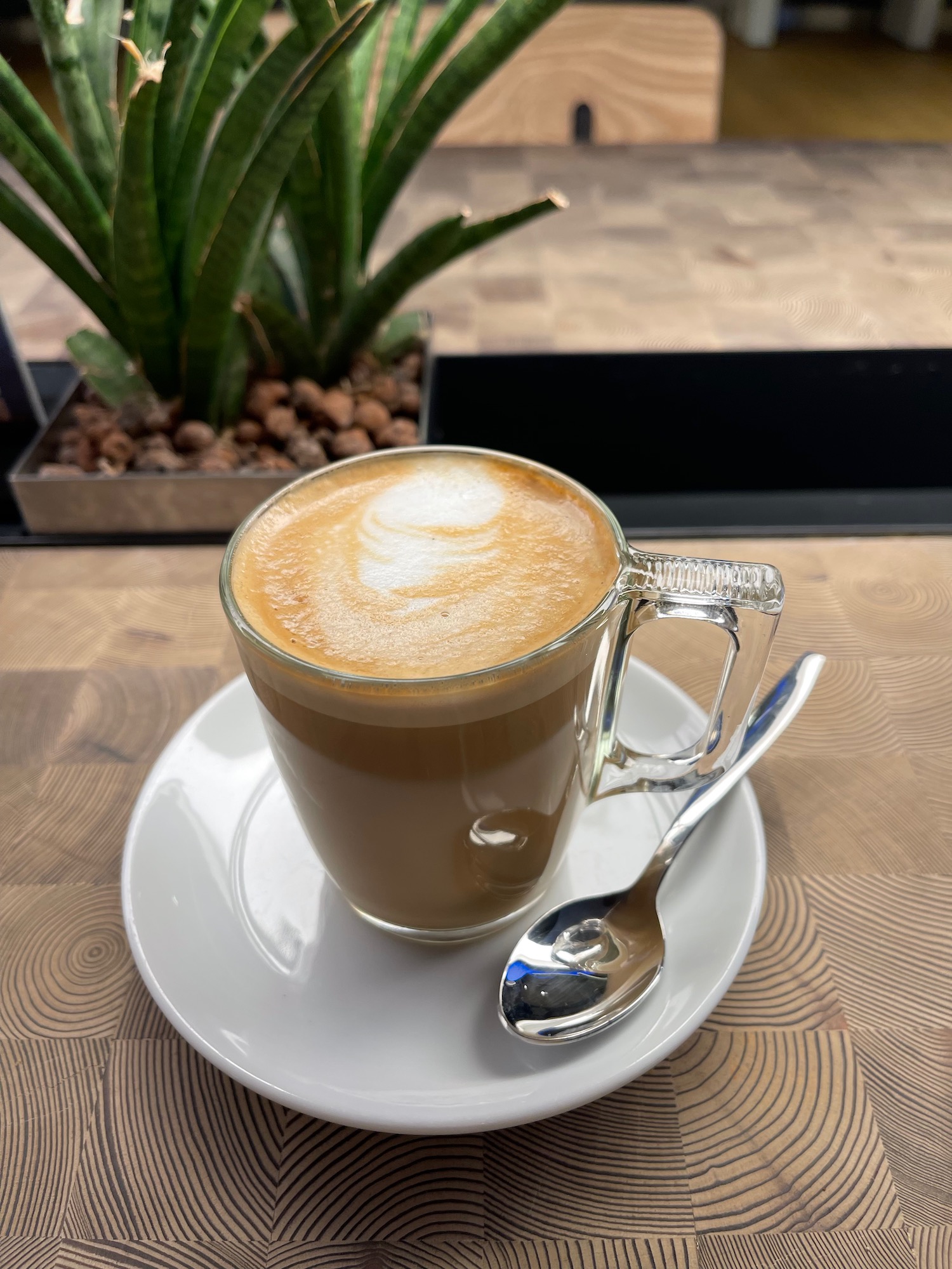 a cup of coffee with a spoon on a saucer