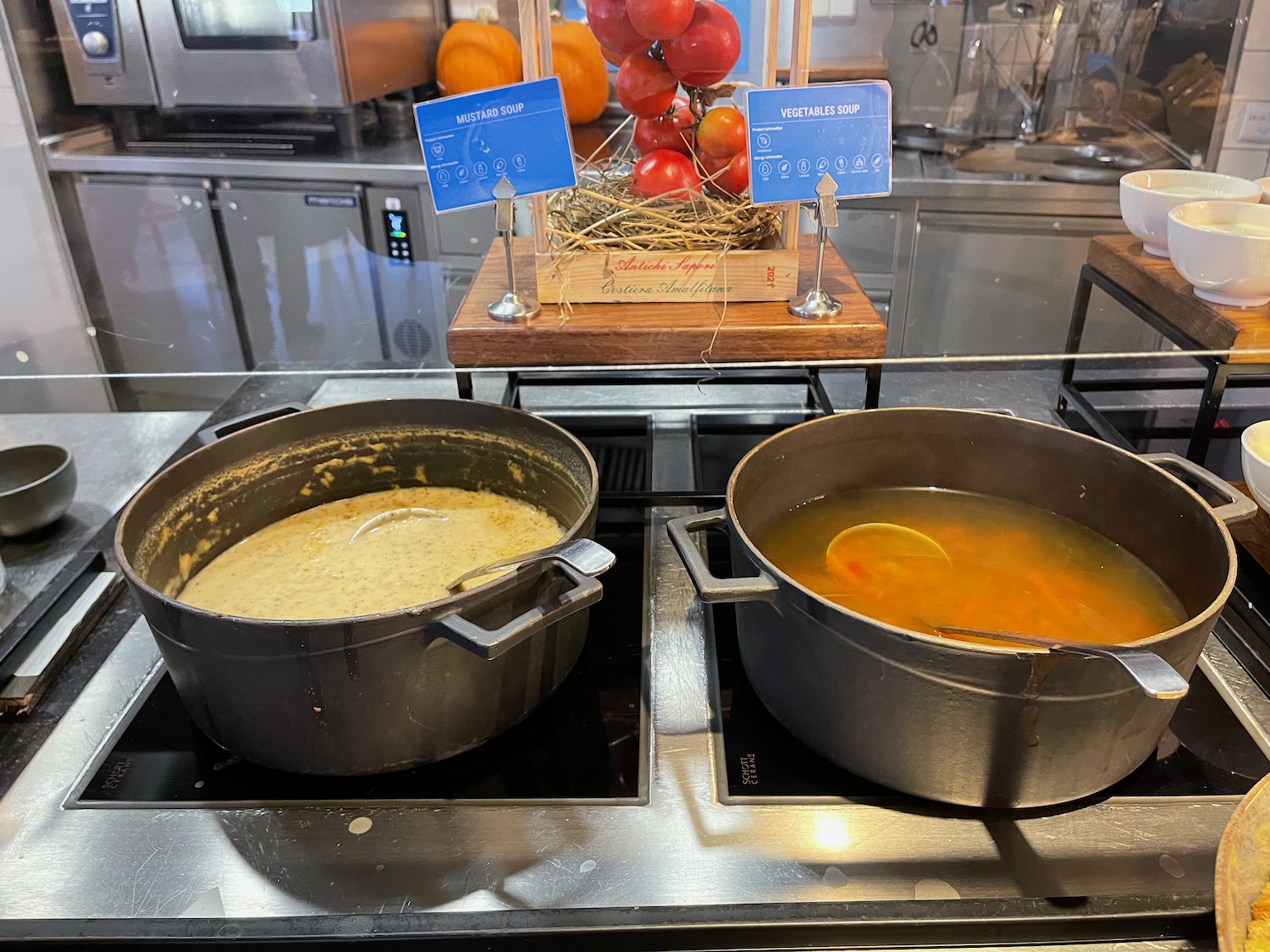 two pots of soup on a stove