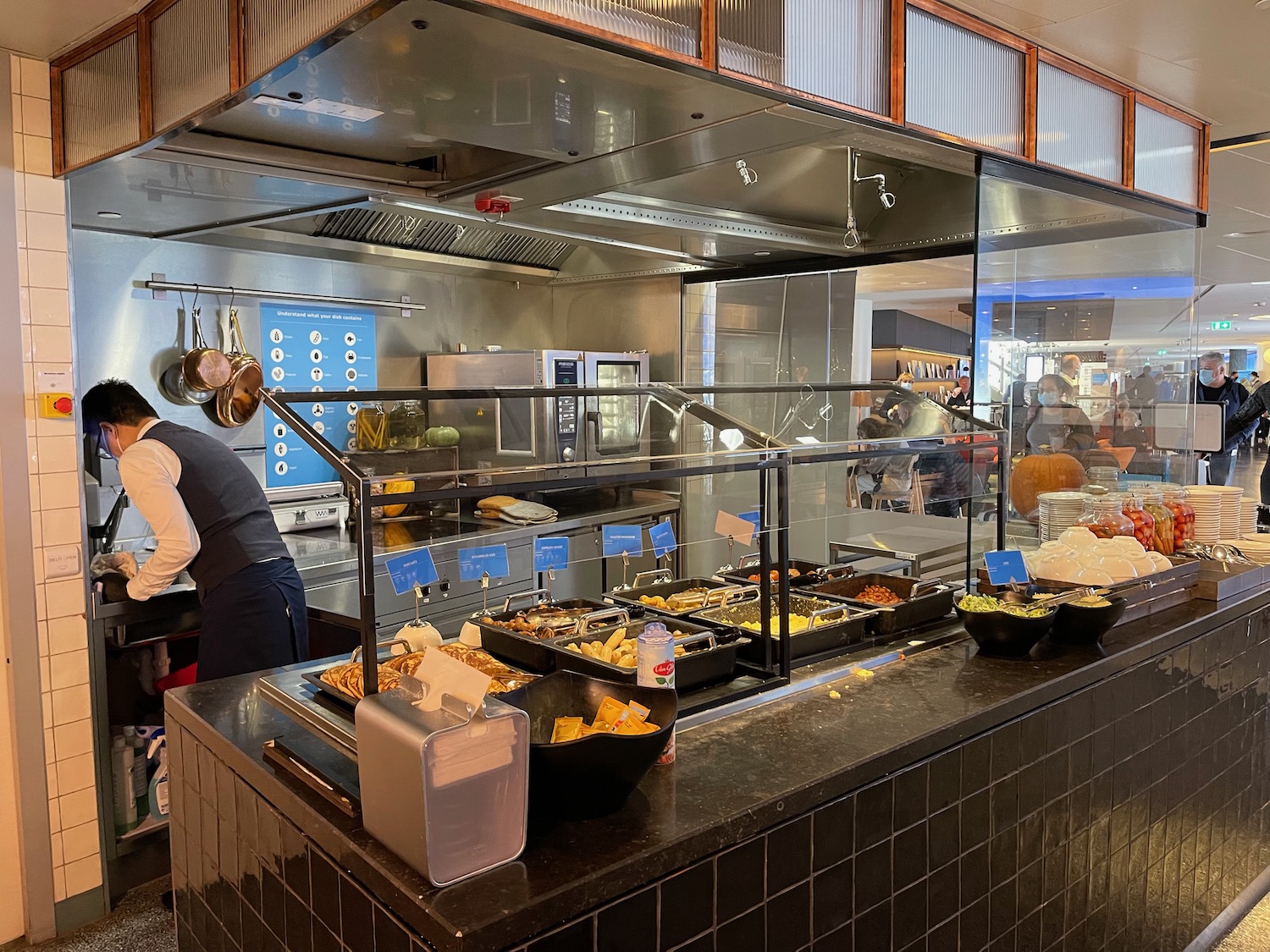 a group of people cooking food in a restaurant