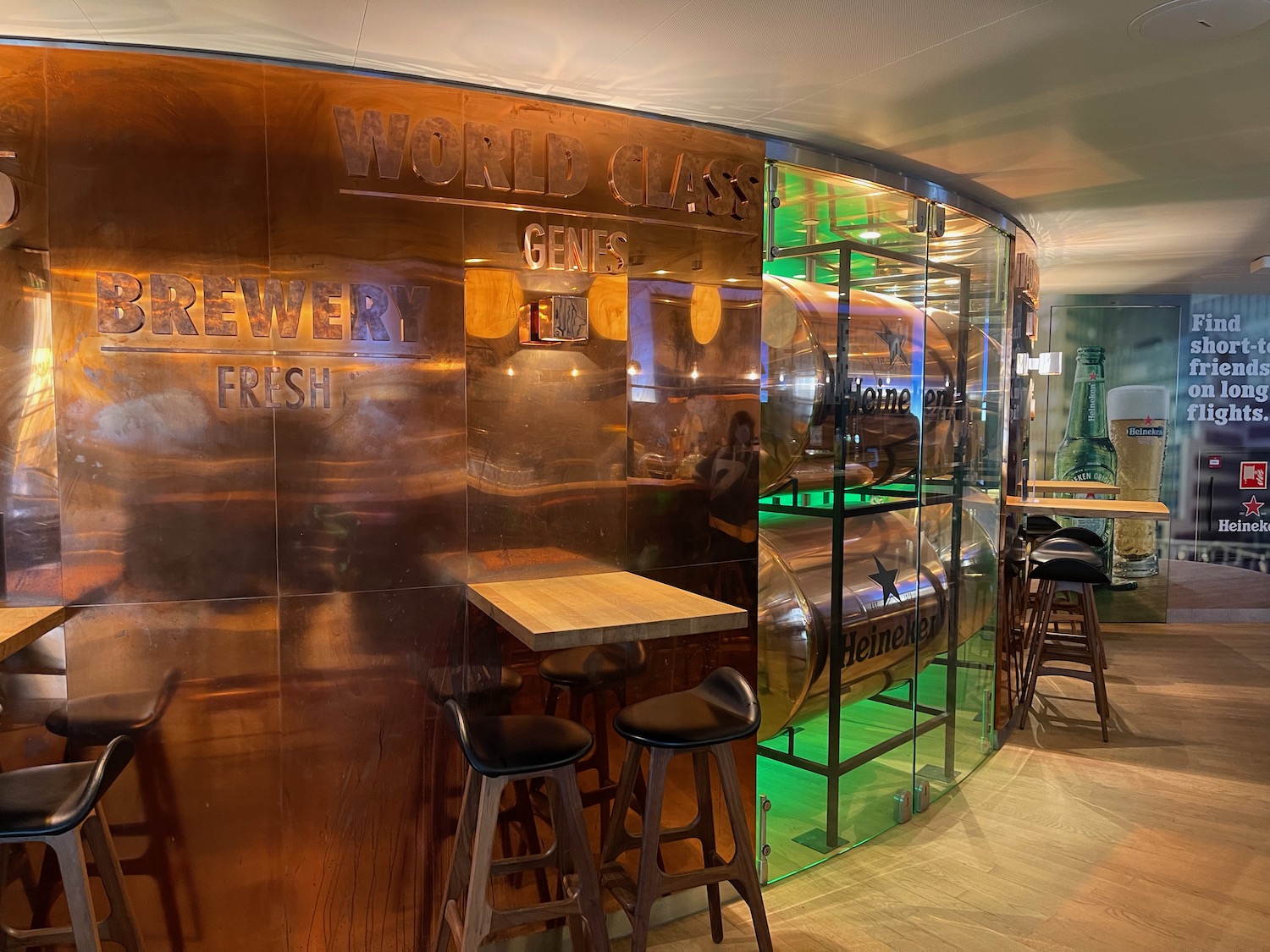 a bar with a glass wall and bar stools