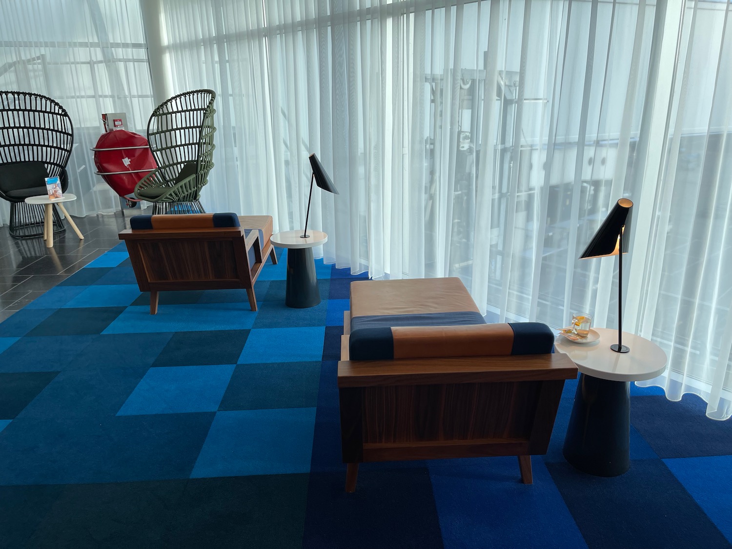 a room with a blue carpet and chairs