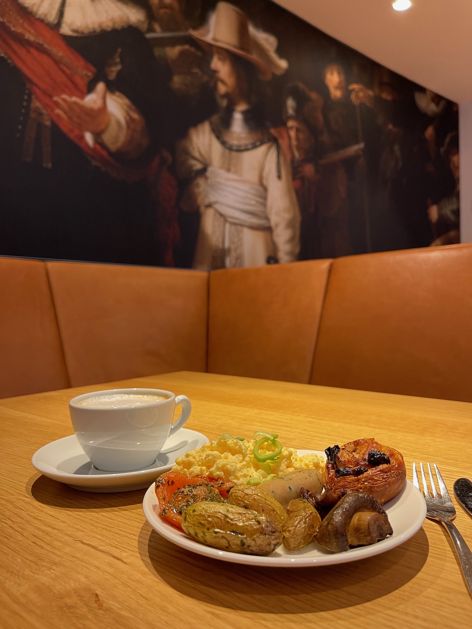 a plate of food and a cup of coffee on a table