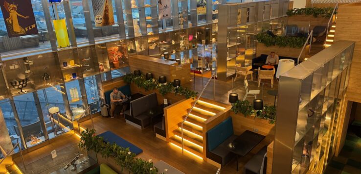 a room with stairs and tables and chairs