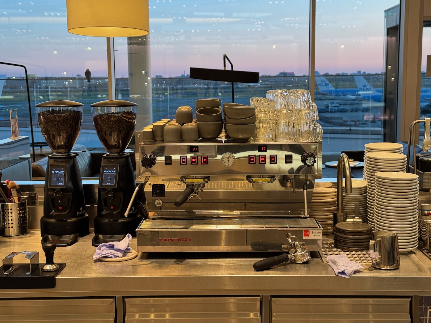 a coffee machine and cups on a counter