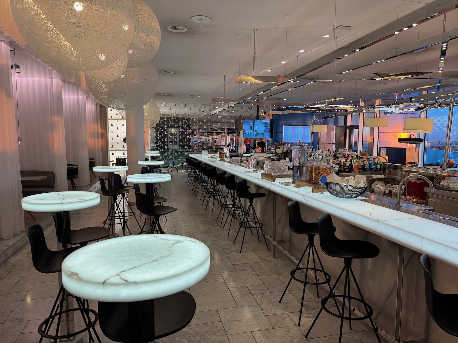 a long bar with tables and chairs