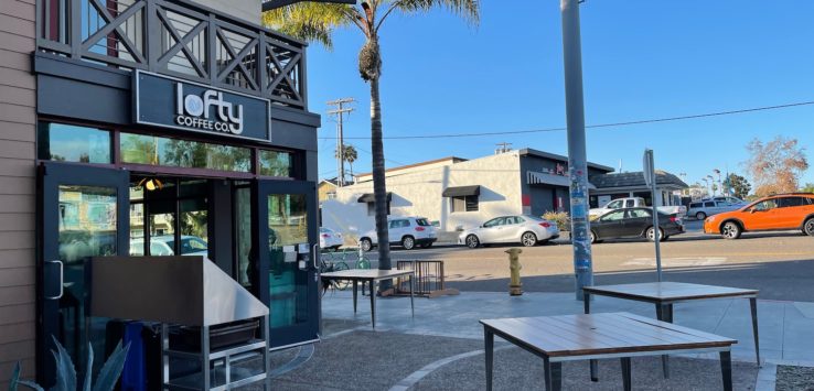 a building with tables and chairs outside