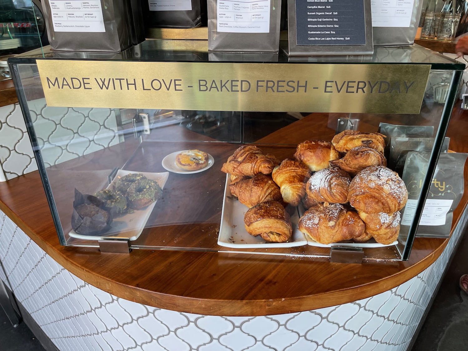 a glass case with pastries on it