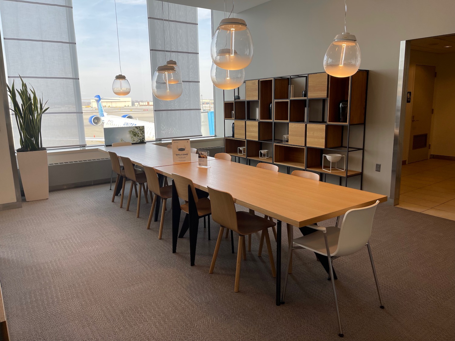 a long table with chairs and a large window