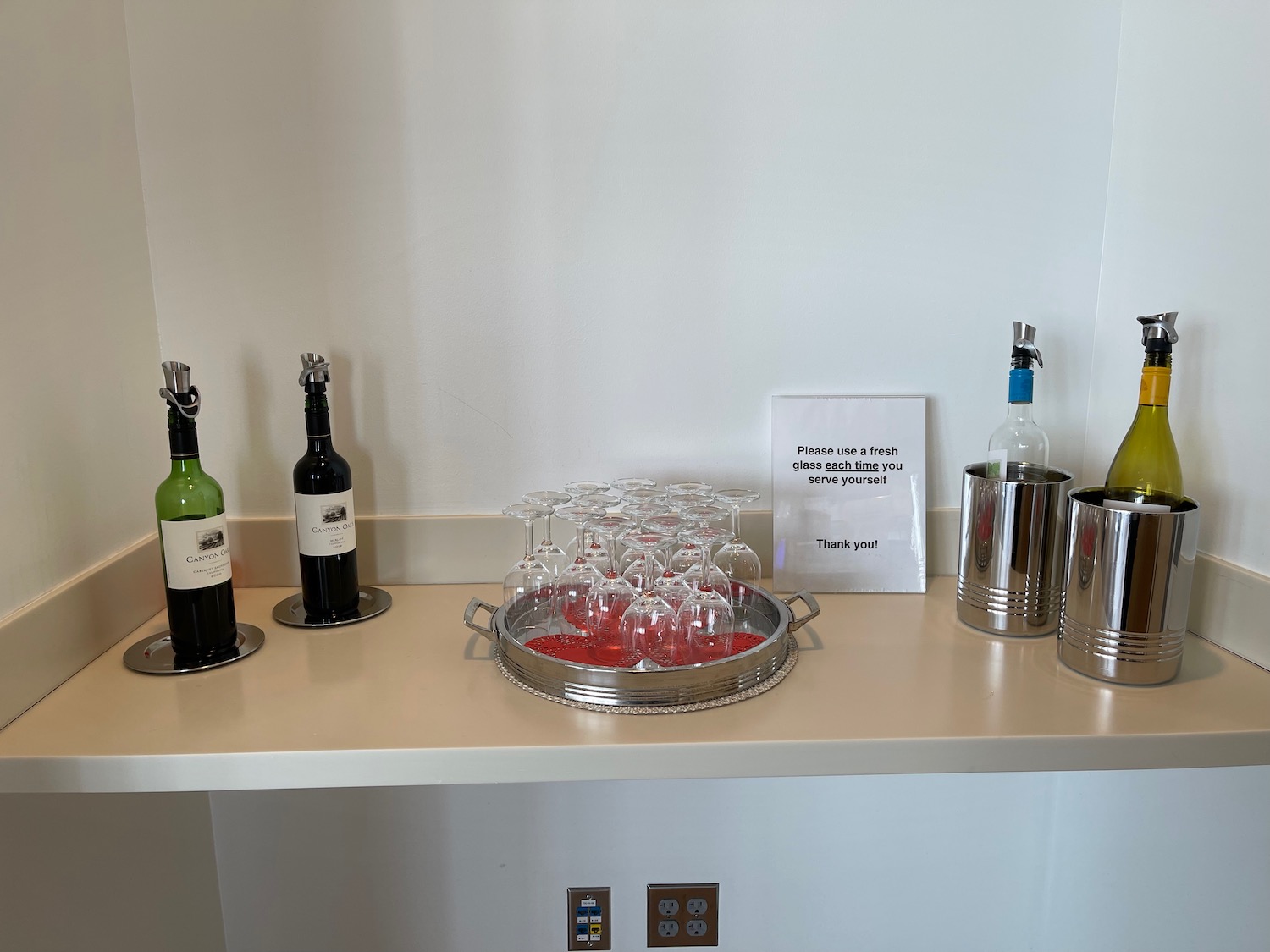 a group of wine glasses and bottles on a counter