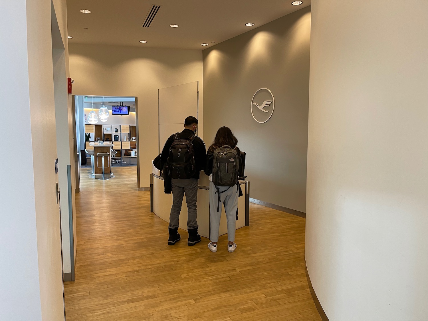 a man and woman standing in a hallway