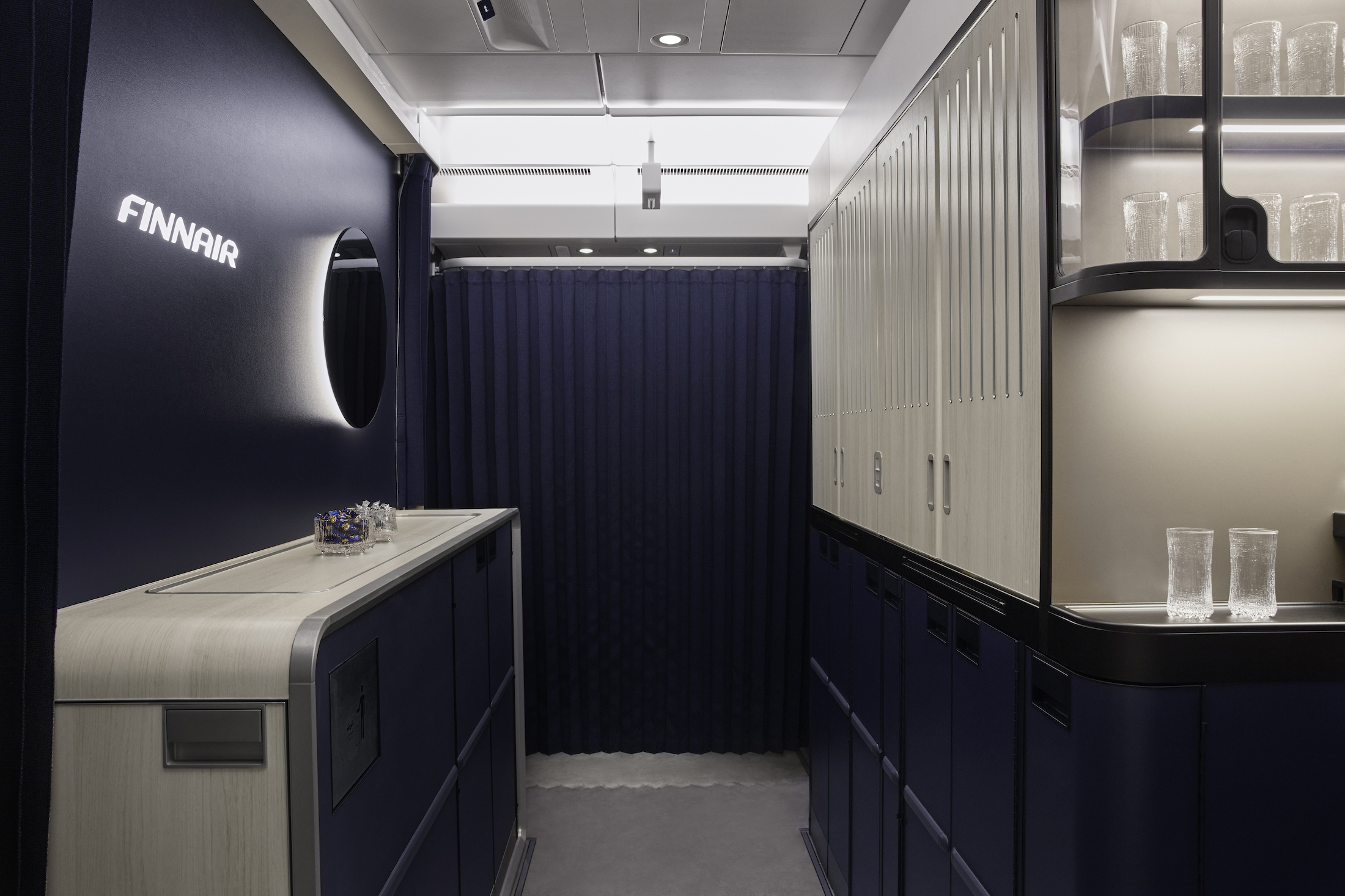 a room with blue curtains and cabinets