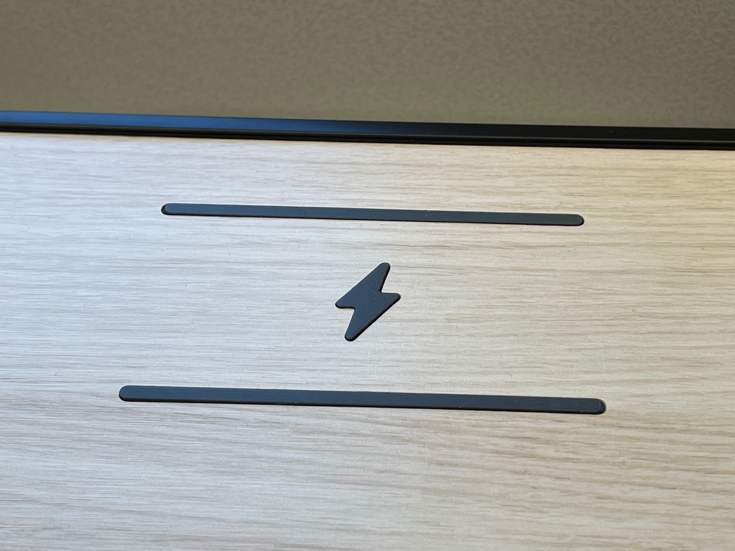 a black lightning bolt on a wood surface