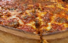 a deep dish pizza with cheese and tomato sauce