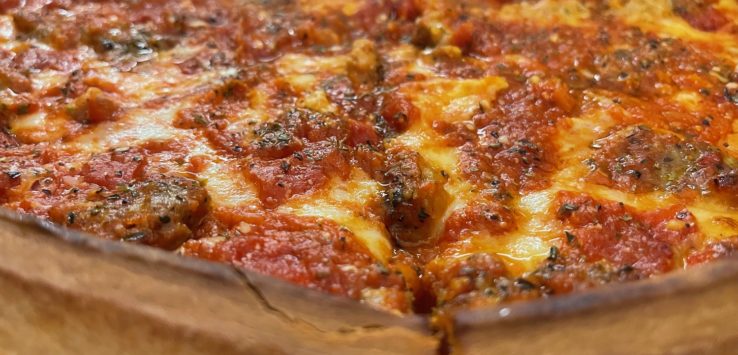 a deep dish pizza with cheese and tomato sauce