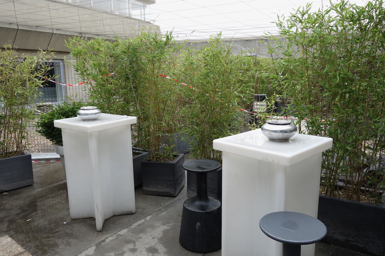 a group of white rectangular containers with a silver bowl on top