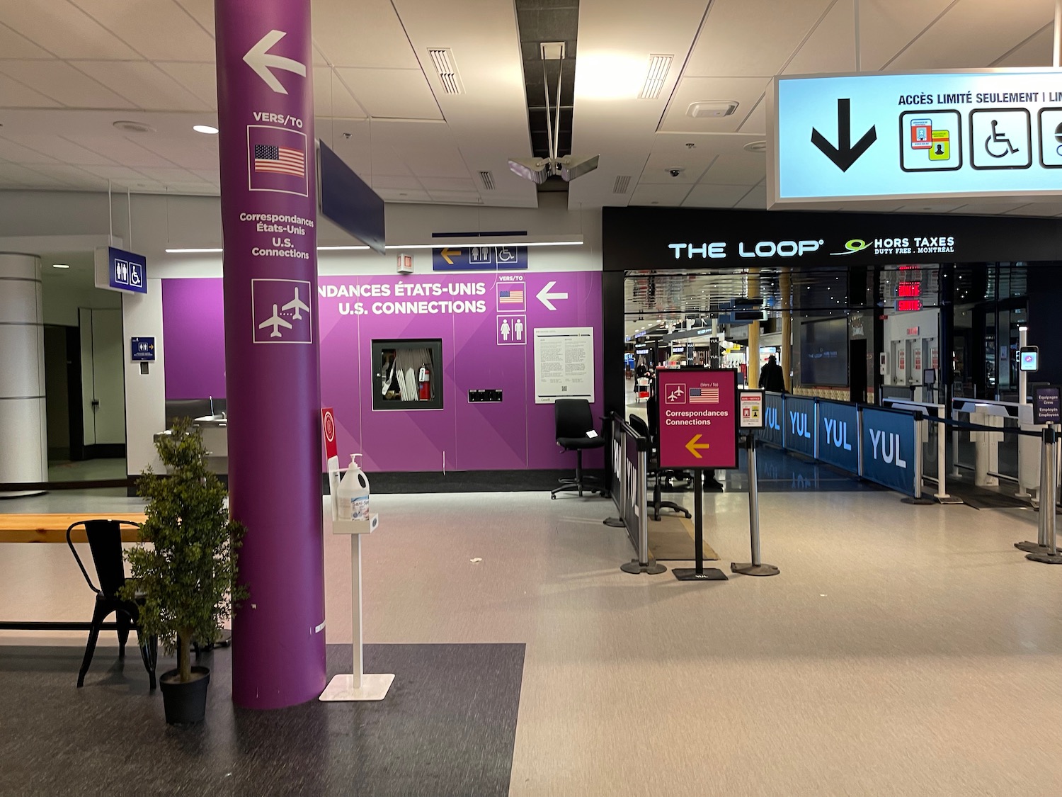 a purple pole with signs and a sign in front of a building