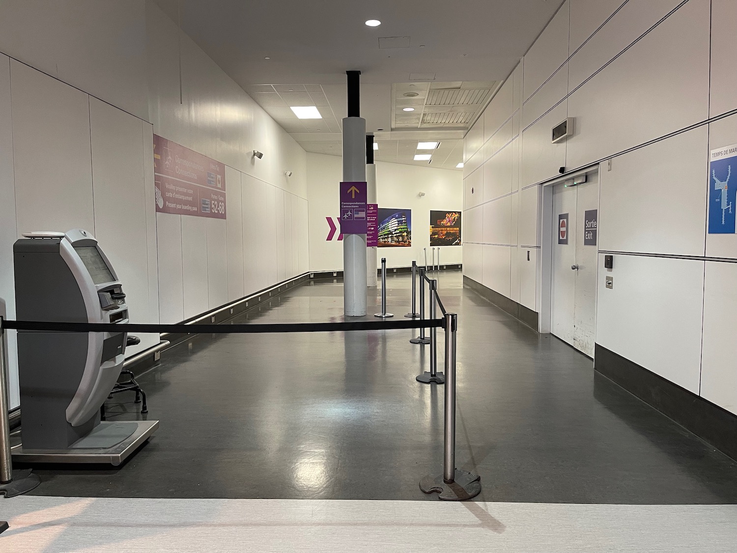 a white hallway with a black rope around it