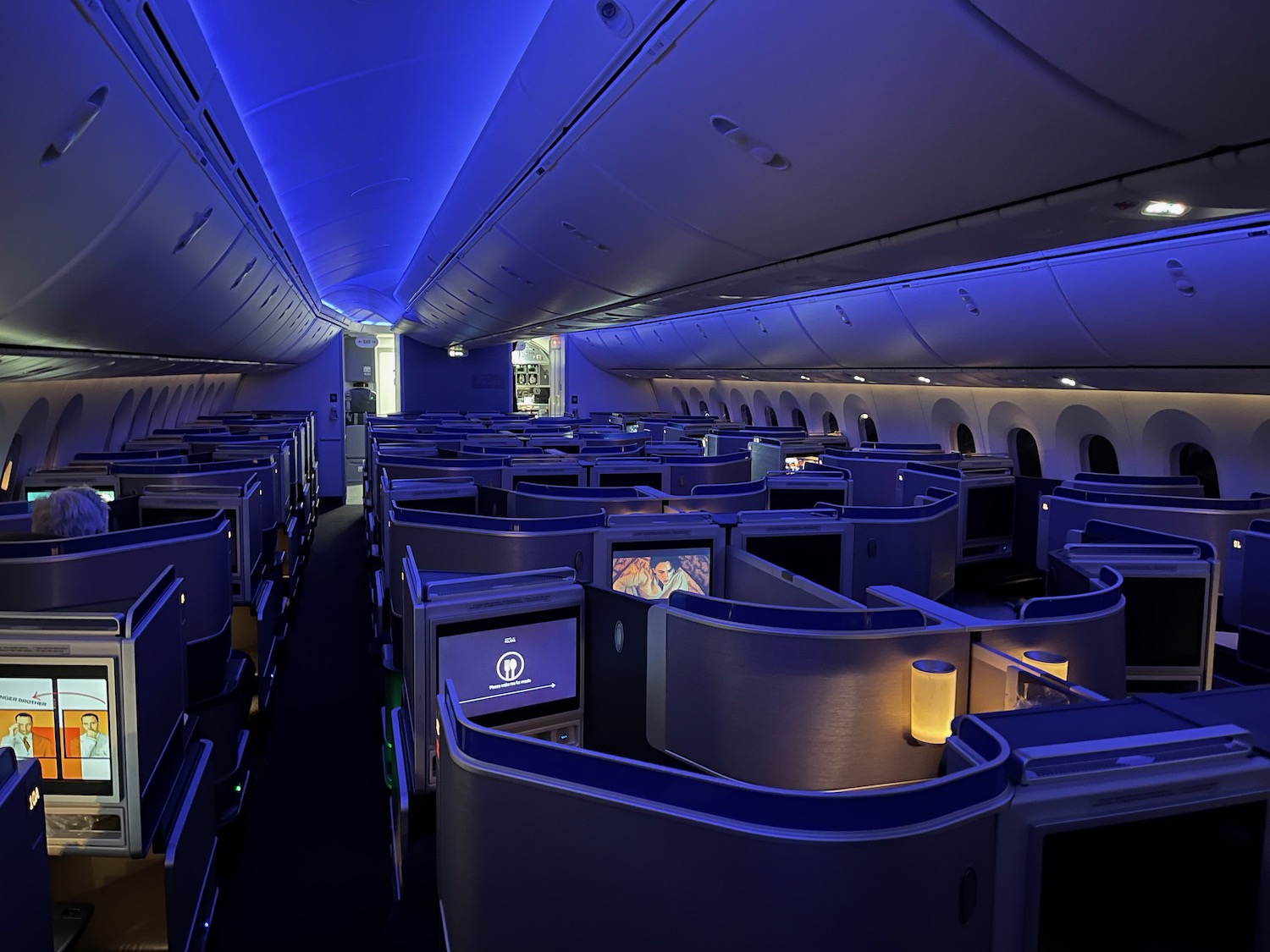 an airplane with rows of seats and a blue light