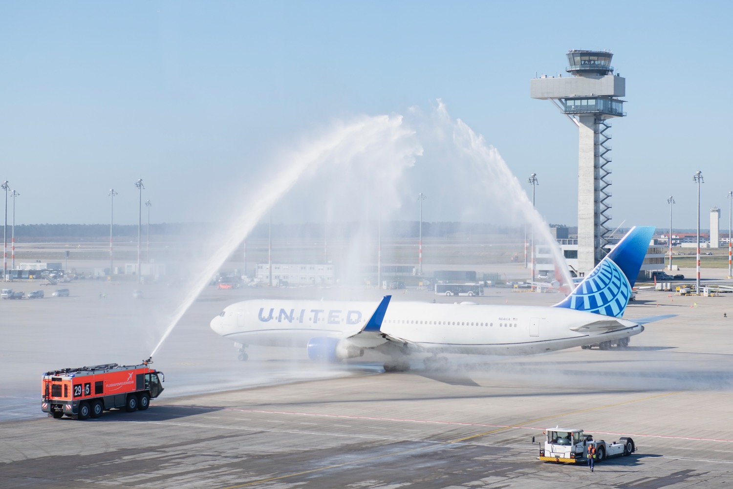 a jet plane spraying water on runway