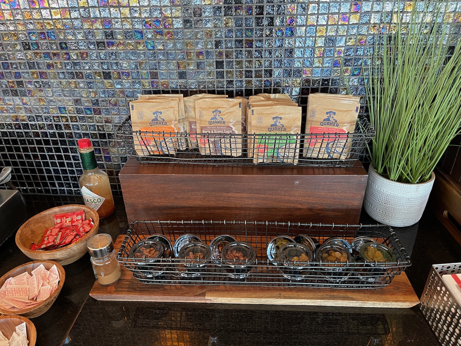 a group of small bowls of condiments on a wooden surface