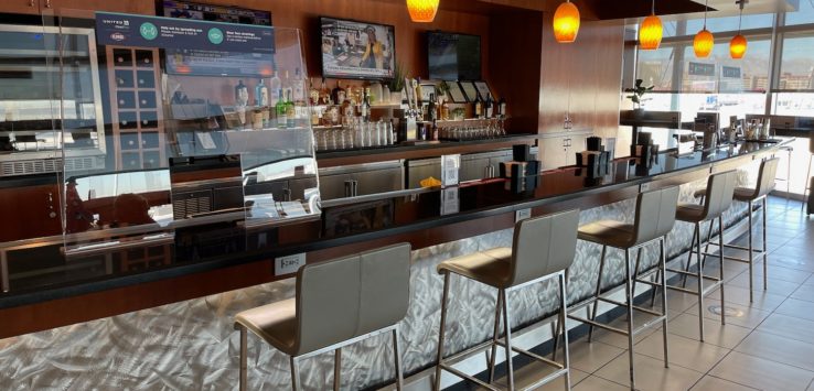 a bar with chairs and a glass case