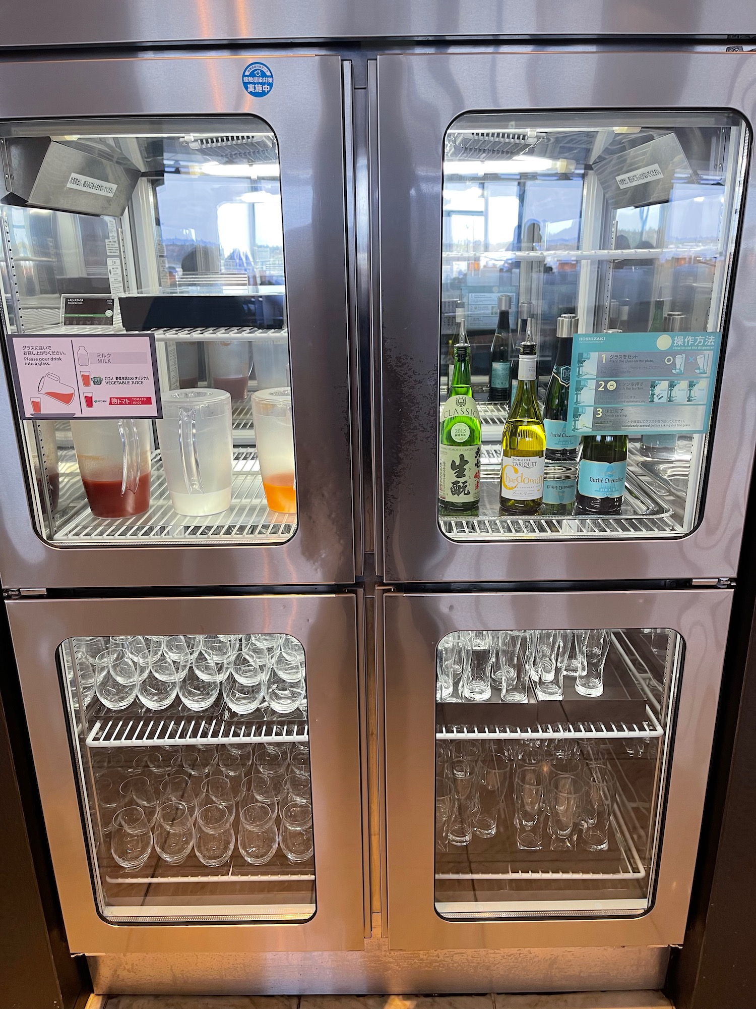a refrigerator with wine glasses and bottles